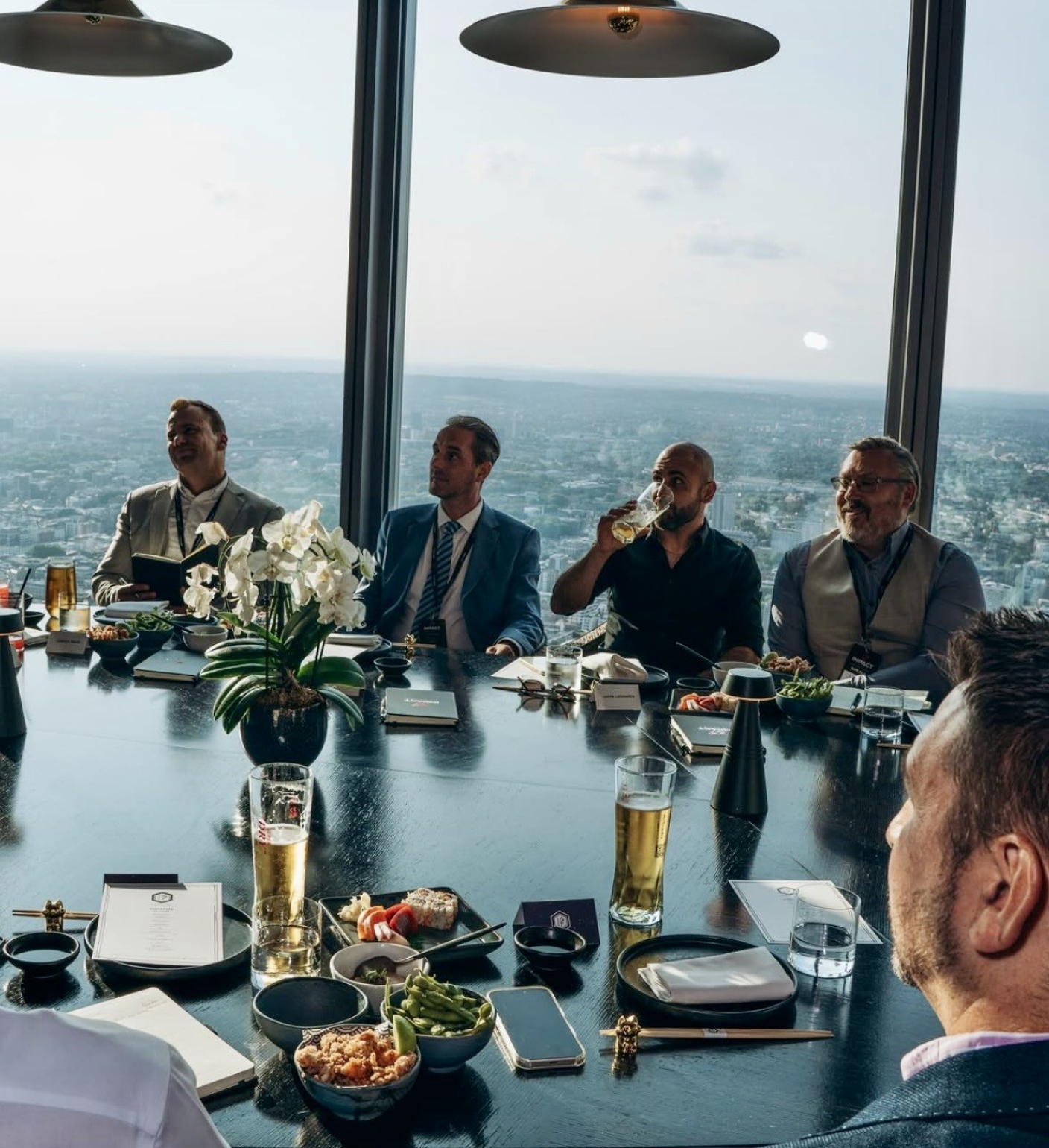 Members at a private boardroom lunch above the city